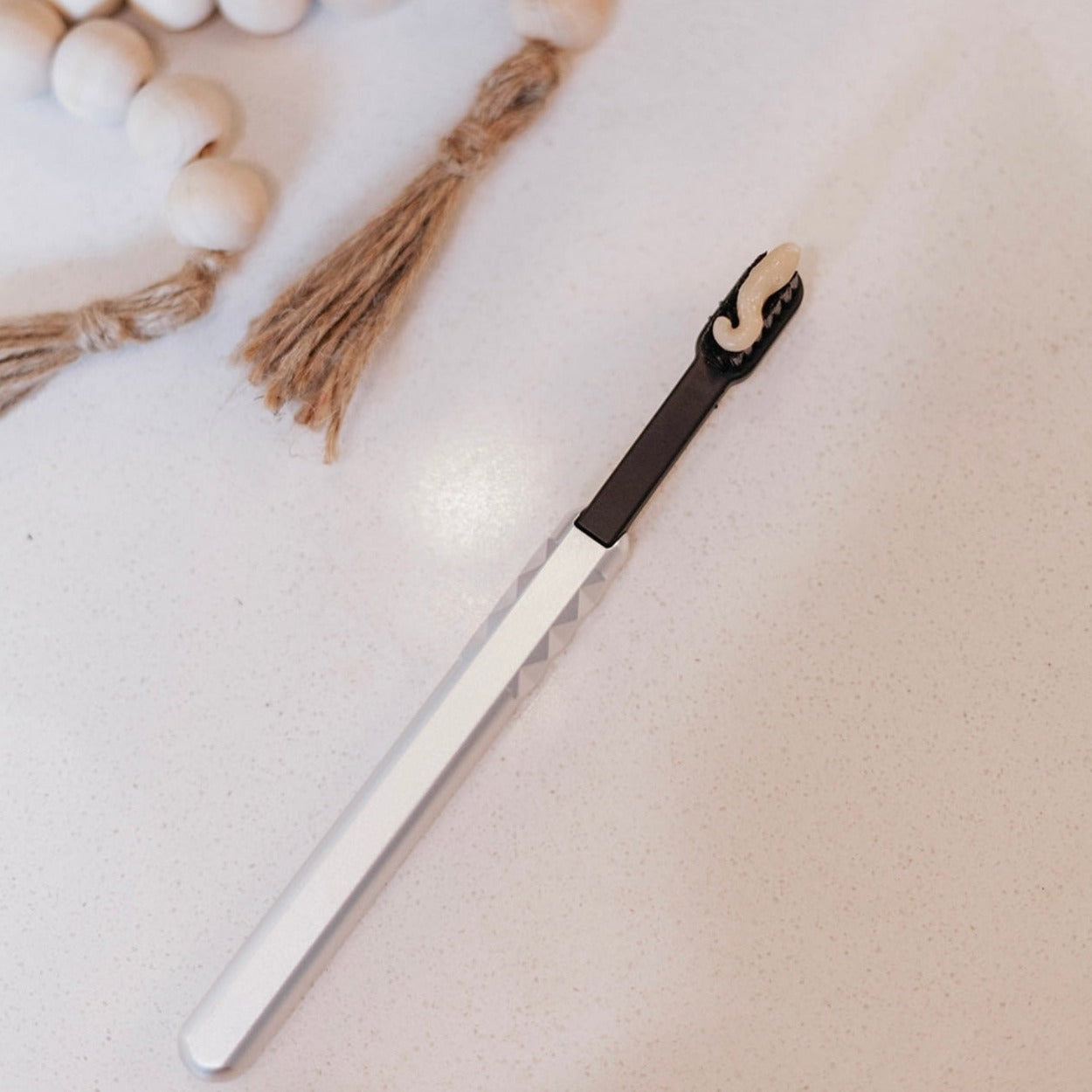 Refreshing Mint Toothpaste Applied to Toothbrush, fluoride free toothpaste, made with avocado oil