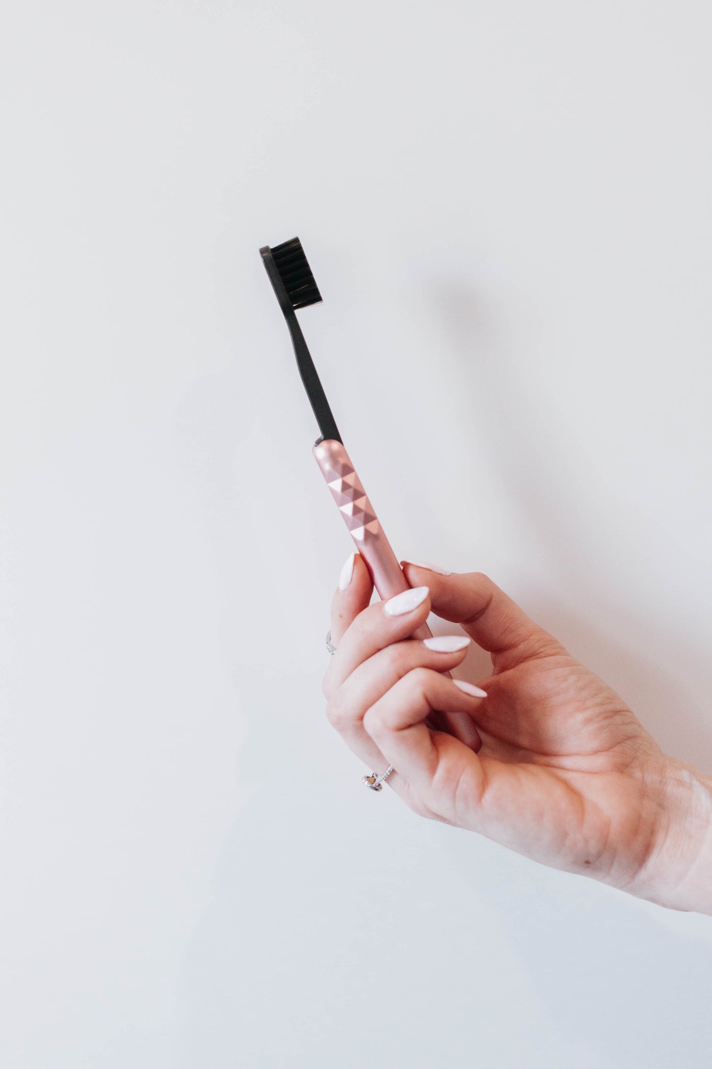 Starter Kit Aluminum Brush Handle and Biodegradable Brush presented in Hand