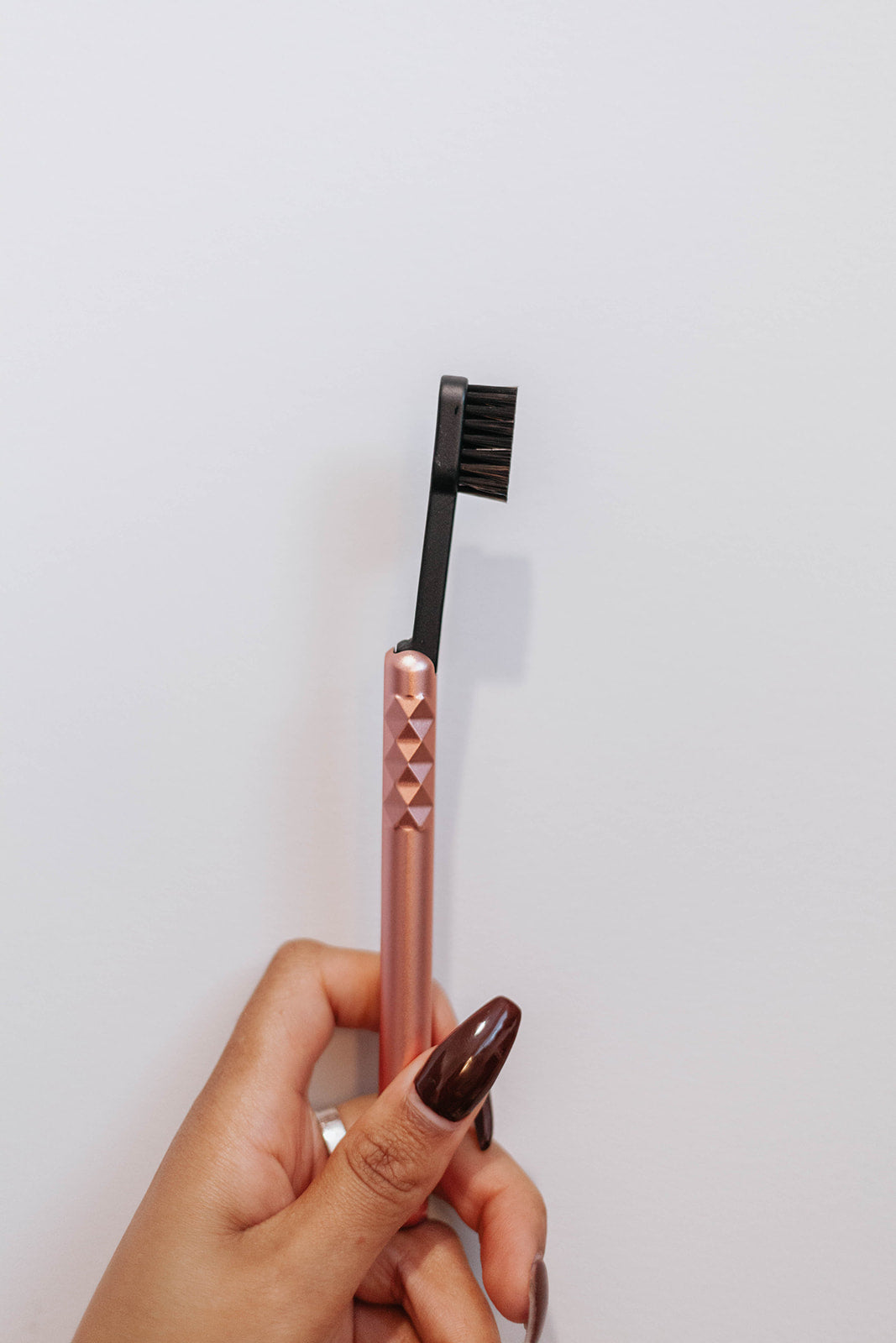 Starter Kit Rose Gold Aluminum Brush Handle and Biodegradable Brush presented in Hand