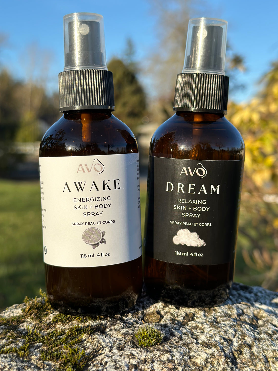 On the left is AWAKE Energizing Skin + Body Spray 4oz, On the Right DREAM Relaxing Skin + Body Spray 4oz, these Organic Remedies are both infused with essential oils