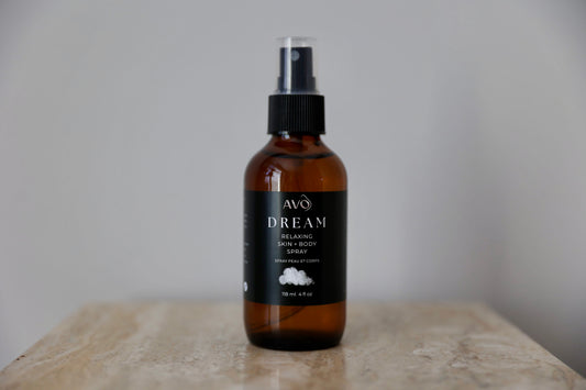 bottle facing forward is Avo's Dream skin and Relaxing Spray made with Organic Simmondsia Chinensis (Jojoba) Oil Steam distilled organic essential oil blend